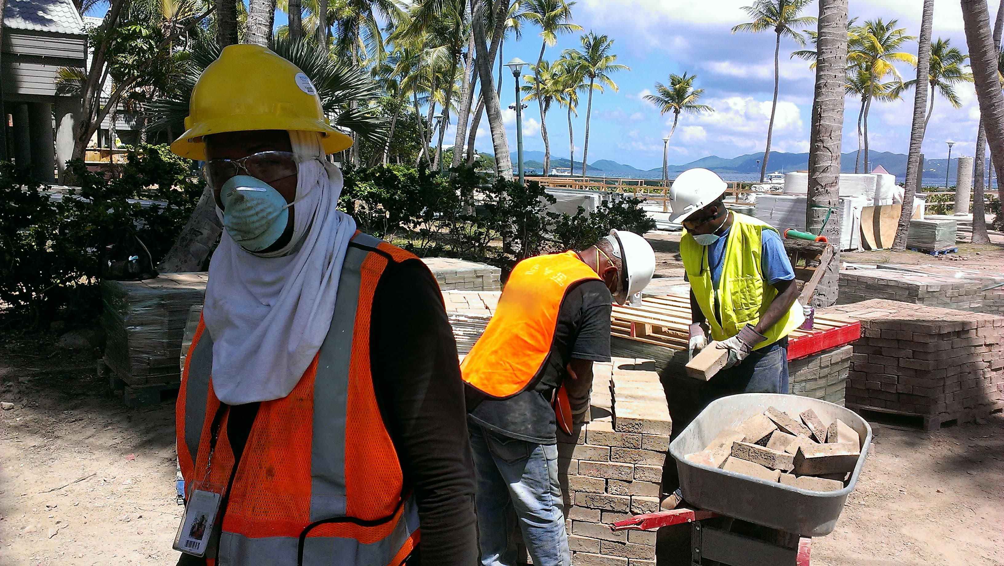 Concrete crew working around a mixer at an active construction site